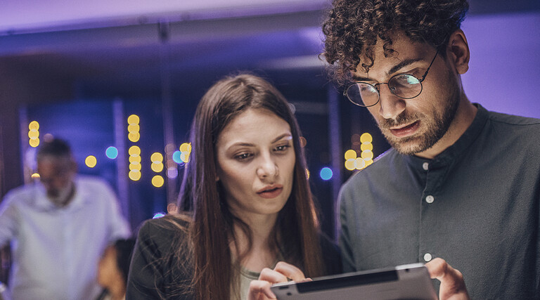 Coworkers reviewing tablet